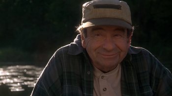 Movie still from “Grumpier Old Men” (1995), directed by Howard Deutch – An older man wearing a hat and a plaid shirt; Close Up shot, Over the shoulder angle