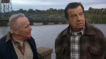Movie still from “Grumpier Old Men” (1995), directed by Howard Deutch – Two older people standing next to each other near a body of water; Medium shot, Over the shoulder angle