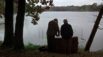 Movie still from “Grumpier Old Men” (1995), directed by Howard Deutch – Two men standing next to a body of water; Wide shot, High angle