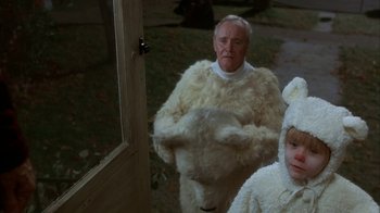 Movie still from “Grumpier Old Men” (1995), directed by Howard Deutch – A man and a child dressed in white costumes; Medium shot, Low angle