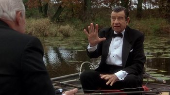 Movie still from “Grumpier Old Men” (1995), directed by Howard Deutch – An older man sitting on a boat in the water; Medium shot, Over the shoulder angle