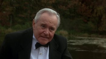 Movie still from “Grumpier Old Men” (1995), directed by Howard Deutch – An older man in a tuxedo sitting in front of a river; Close Up shot, Over the shoulder angle