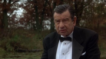 Movie still from “Grumpier Old Men” (1995), directed by Howard Deutch – An older man wearing a tuxedo and a bow tie; Close Up shot, Over the shoulder angle