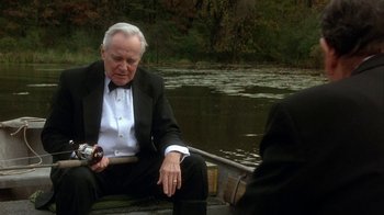 Movie still from “Grumpier Old Men” (1995), directed by Howard Deutch – An older man sitting on a boat in the water; Medium shot, High angle