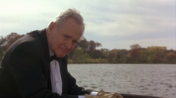 Movie still from “Grumpier Old Men” (1995), directed by Howard Deutch – An older man sitting on a boat in the water; Medium shot, Low angle