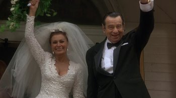 Movie still from “Grumpier Old Men” (1995), directed by Howard Deutch – A man and a woman in wedding dress and tuxedo; Medium shot, High angle