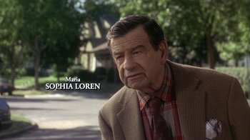 Movie still from “Grumpier Old Men” (1995), directed by Howard Deutch – An older man wearing a plaid shirt and a brown jacket; Close Up shot, Over the shoulder angle