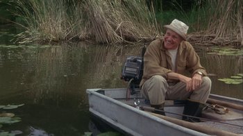 Movie still from “Grumpier Old Men” (1995), directed by Howard Deutch – A man sitting in a boat on the water; Medium shot, Low angle