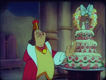 Movie still from “Gulliver's Travels” (1939), directed by William Henning – A man in a costume standing in front of a cake; Wide shot, Over the shoulder angle
