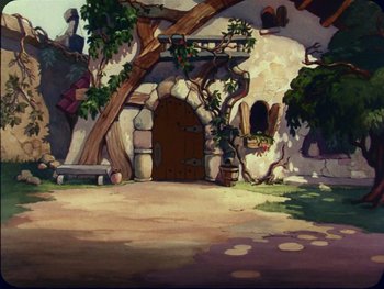 Movie still from “Gulliver's Travels” (1939), directed by William Henning – An animated scene of a cave with a tree and a bench; Wide shot, High angle