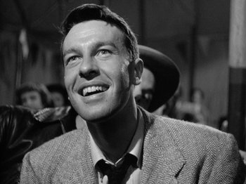 Movie still from “Gun Crazy” (1950), directed by Joseph H. Lewis – An old photo of a man smiling for the camera; Close Up shot, Low angle