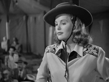 Movie still from “Gun Crazy” (1950), directed by Joseph H. Lewis – A black and white photo of a woman wearing a cowboy hat; Medium shot, Over the shoulder angle