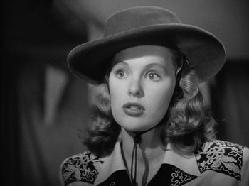 Movie still from “Gun Crazy” (1950), directed by Joseph H. Lewis – A black and white photo of a woman wearing a hat; Close Up shot, Low angle
