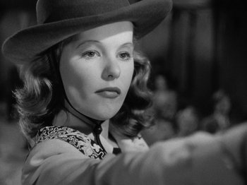 Movie still from “Gun Crazy” (1950), directed by Joseph H. Lewis – A black and white photo of a woman wearing a cowboy hat; Close Up shot, Low angle