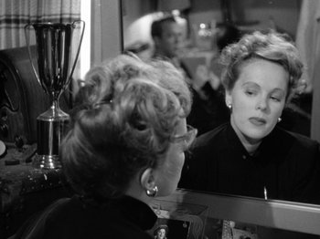 Movie still from “Gun Crazy” (1950), directed by Joseph H. Lewis – An older woman looking in the mirror in a salon; Close Up shot, Over the shoulder angle