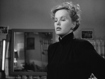 Movie still from “Gun Crazy” (1950), directed by Joseph H. Lewis – A black and white photo of a woman looking at the camera; Close Up shot, Low angle