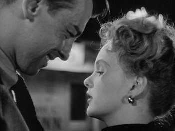 Movie still from “Gun Crazy” (1950), directed by Joseph H. Lewis – A black and white photo of a man and a woman looking at each other; Close Up shot, Over the shoulder angle