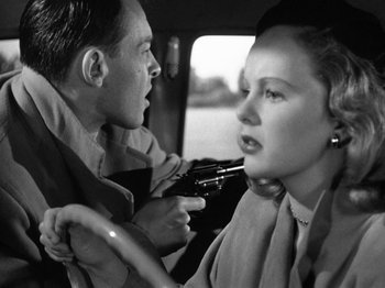 Movie still from “Gun Crazy” (1950), directed by Joseph H. Lewis – A man and a woman in the back seat of a car; Close Up shot, Over the shoulder angle