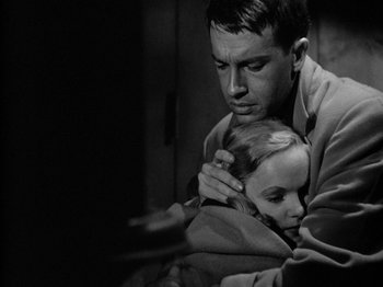 Movie still from “Gun Crazy” (1950), directed by Joseph H. Lewis – A black and white photo of a man and a girl; Close Up shot, Over the shoulder angle
