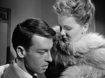 Movie still from “Gun Crazy” (1950), directed by Joseph H. Lewis – A man and a woman in a fur trimmed coat; Close Up shot, Over the shoulder angle