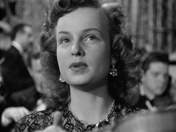 Movie still from “Gun Crazy” (1950), directed by Joseph H. Lewis – An old photo of a woman in a black and white photo; Close Up shot, Low angle