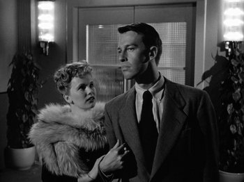 Movie still from “Gun Crazy” (1950), directed by Joseph H. Lewis – A man and a woman standing next to each other; Medium shot, Low angle