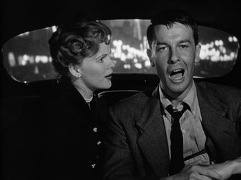 Movie still from “Gun Crazy” (1950), directed by Joseph H. Lewis – A man and a woman sitting in the back of a car; Close Up shot, Low angle
