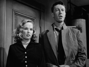 Movie still from “Gun Crazy” (1950), directed by Joseph H. Lewis – A man and a woman standing next to each other; Medium shot, Low angle