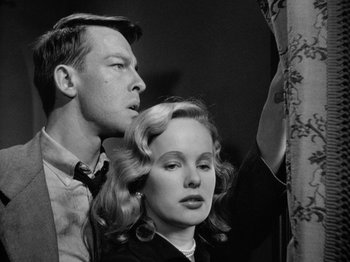 Movie still from “Gun Crazy” (1950), directed by Joseph H. Lewis – A black and white photo of a man and a woman; Medium shot, Low angle