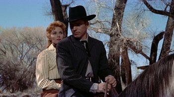 Movie still from “Gunfight at the O.K. Corral” (1957), directed by John Sturges – A man and a woman are riding a horse together; Medium shot, Low angle