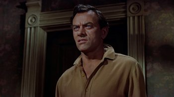 Movie still from “Gunfight at the O.K. Corral” (1957), directed by John Sturges – A person standing in a room near a door; Close Up shot, Low angle