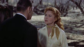 Movie still from “Gunfight at the O.K. Corral” (1957), directed by John Sturges – An older man and a younger woman in a field; Close Up shot, Over the shoulder angle