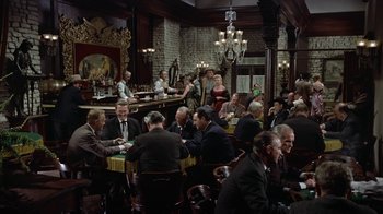 Movie still from “Gunfight at the O.K. Corral” (1957), directed by John Sturges – A group of men sitting at a table in a restaurant; Wide shot, High angle