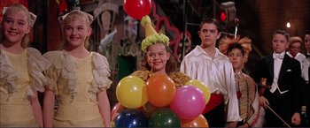 Movie still from “Gypsy” (1962), directed by Mervyn LeRoy – A little girl wearing a clown costume and holding balloons; Medium shot, Low angle