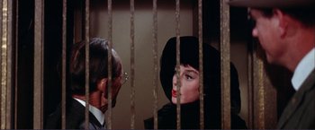Movie still from “Gypsy” (1962), directed by Mervyn LeRoy – A man and a woman are in a jail cell; Close Up shot, Low angle