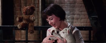 Movie still from “Gypsy” (1962), directed by Mervyn LeRoy – A woman holding a lamb in her arms; Close Up shot, High angle