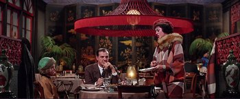 Movie still from “Gypsy” (1962), directed by Mervyn LeRoy – A man and a woman sitting at a table in a restaurant; Wide shot, Low angle