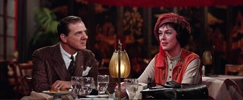Movie still from “Gypsy” (1962), directed by Mervyn LeRoy – A man and a woman sitting at a dinner table; Medium shot, Over the shoulder angle