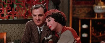 Movie still from “Gypsy” (1962), directed by Mervyn LeRoy – An older man standing next to an older woman; Close Up shot, Low angle