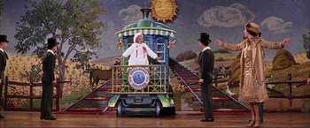 Movie still from “Gypsy” (1962), directed by Mervyn LeRoy – A man and a woman standing in front of a train on a stage; Wide shot, Low angle