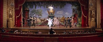 Movie still from “Gypsy” (1962), directed by Mervyn LeRoy – A scene of a stage with a person in a white costume; Extreme Wide shot, Low angle