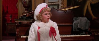 Movie still from “Gypsy” (1962), directed by Mervyn LeRoy – A little girl dressed in a white coat and red hat; Close Up shot, High angle