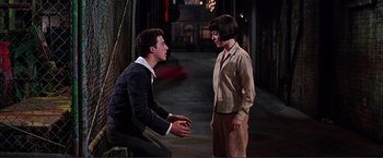 Movie still from “Gypsy” (1962), directed by Mervyn LeRoy – A man and a woman talking to each other in an alley; Medium shot, Over the shoulder angle