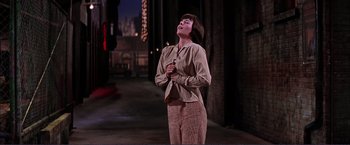 Movie still from “Gypsy” (1962), directed by Mervyn LeRoy – A woman standing on a stage with her eyes closed; Medium shot, Low angle
