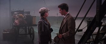 Movie still from “Gypsy” (1962), directed by Mervyn LeRoy – A man and a woman standing next to each other; Medium shot, Low angle