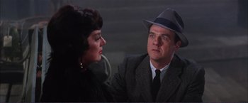 Movie still from “Gypsy” (1962), directed by Mervyn LeRoy – A man and a woman in a suit and hat; Close Up shot, Over the shoulder angle