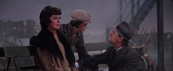 Movie still from “Gypsy” (1962), directed by Mervyn LeRoy – A group of people sitting on top of a wooden bench; Medium shot, Over the shoulder angle