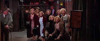 Movie still from “Gypsy” (1962), directed by Mervyn LeRoy – A group of women dressed up in vintage clothing; Wide shot, High angle