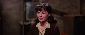 Movie still from “Gypsy” (1962), directed by Mervyn LeRoy – A young woman in a brown jacket is smiling for the camera; Close Up shot, High angle