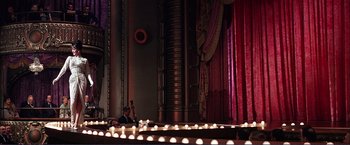 Movie still from “Gypsy” (1962), directed by Mervyn LeRoy – A man playing a violin in a theater; Extreme Wide shot, Low angle